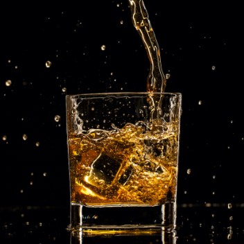 Whiskey Splashing Into Glass